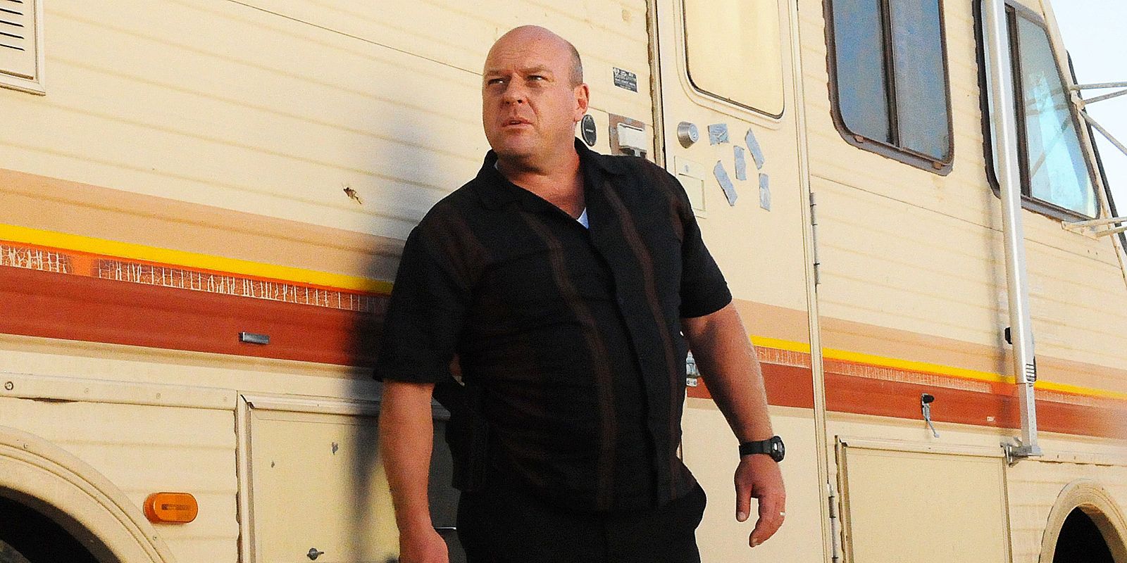 Dean Norris as Hank Schrader, standing outside the infamous Breaking Bad RV.