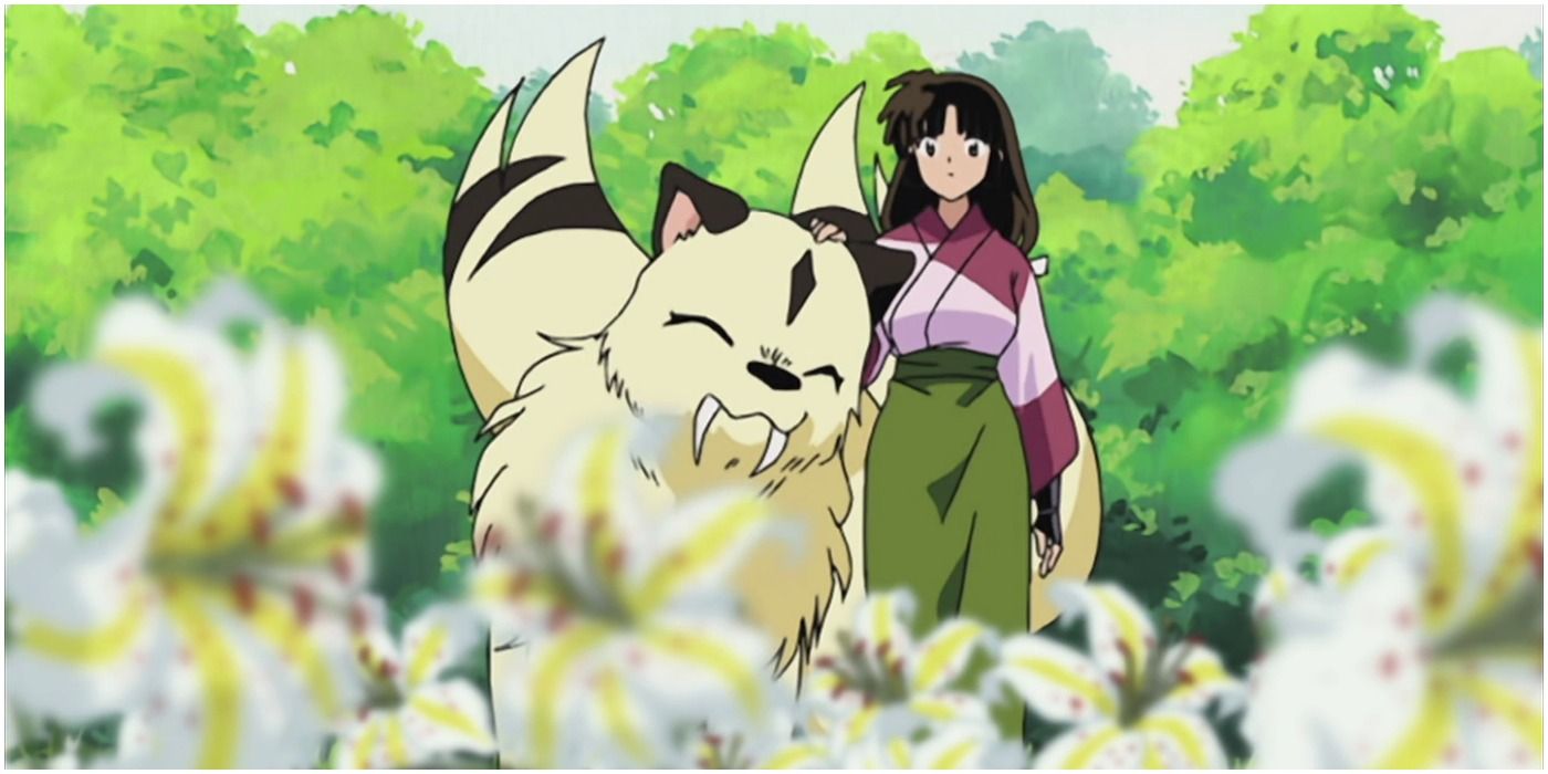 Kirara nuzzles Sango in a flower filled meadow in Inuyasha