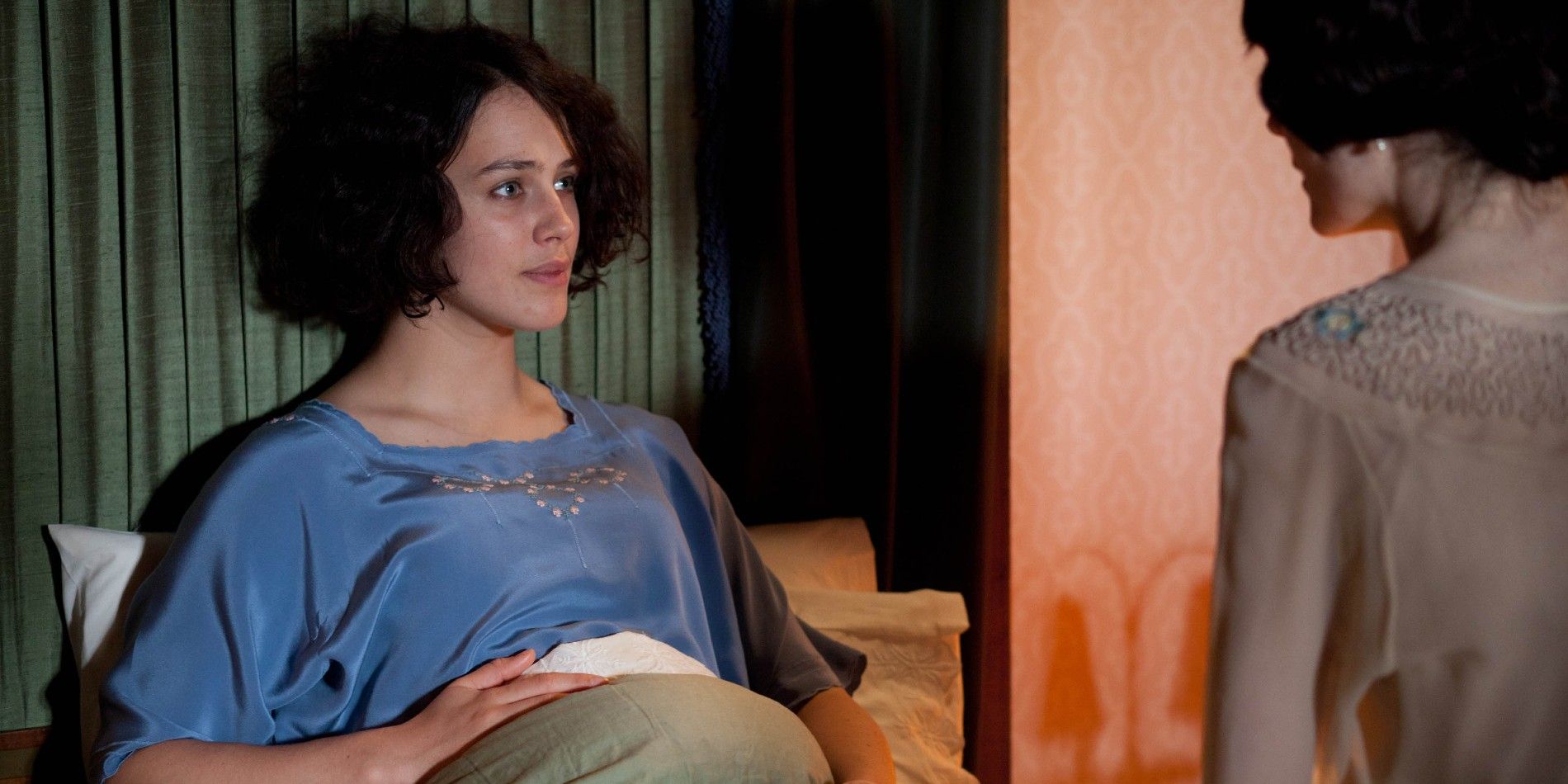 Lady Sybil (Jessica Brown Findlay) sits in bed with her mother Cora.