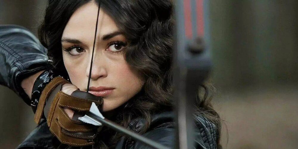 Allison Argent holds a bow and arrow during a scene in the Teen Wolf series