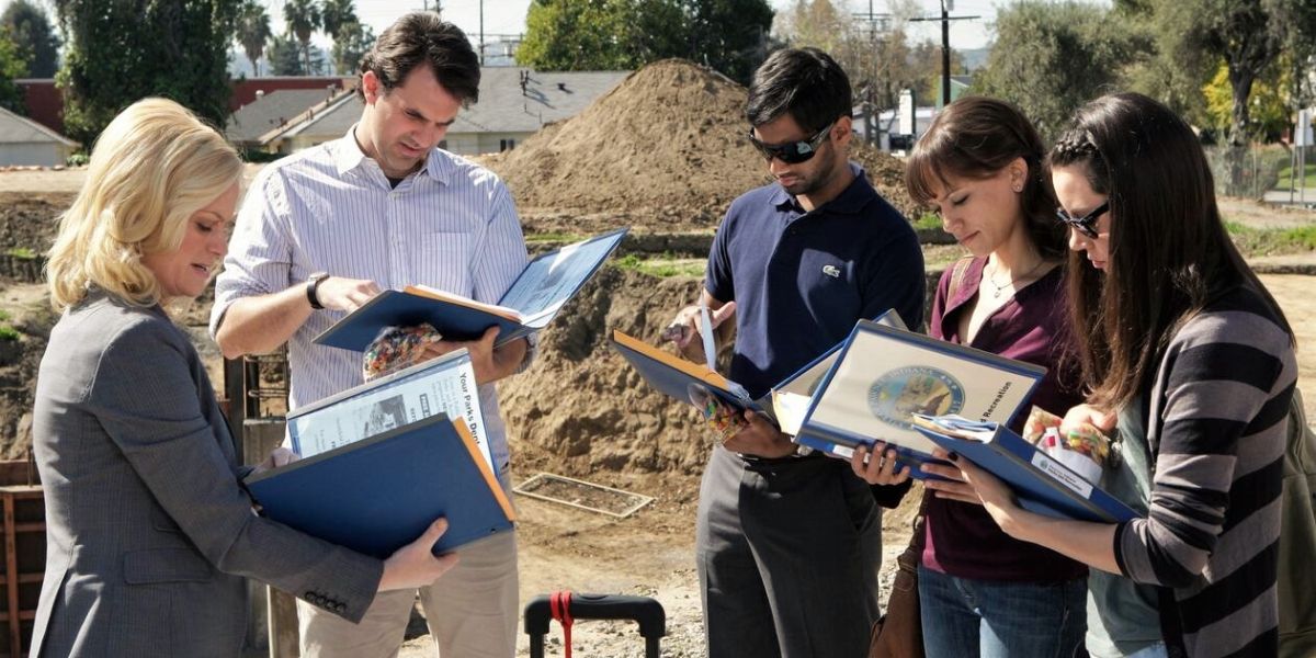 Leslie Knope, Mark, Tom, Ann, and April go over binders in Parks and Recreation