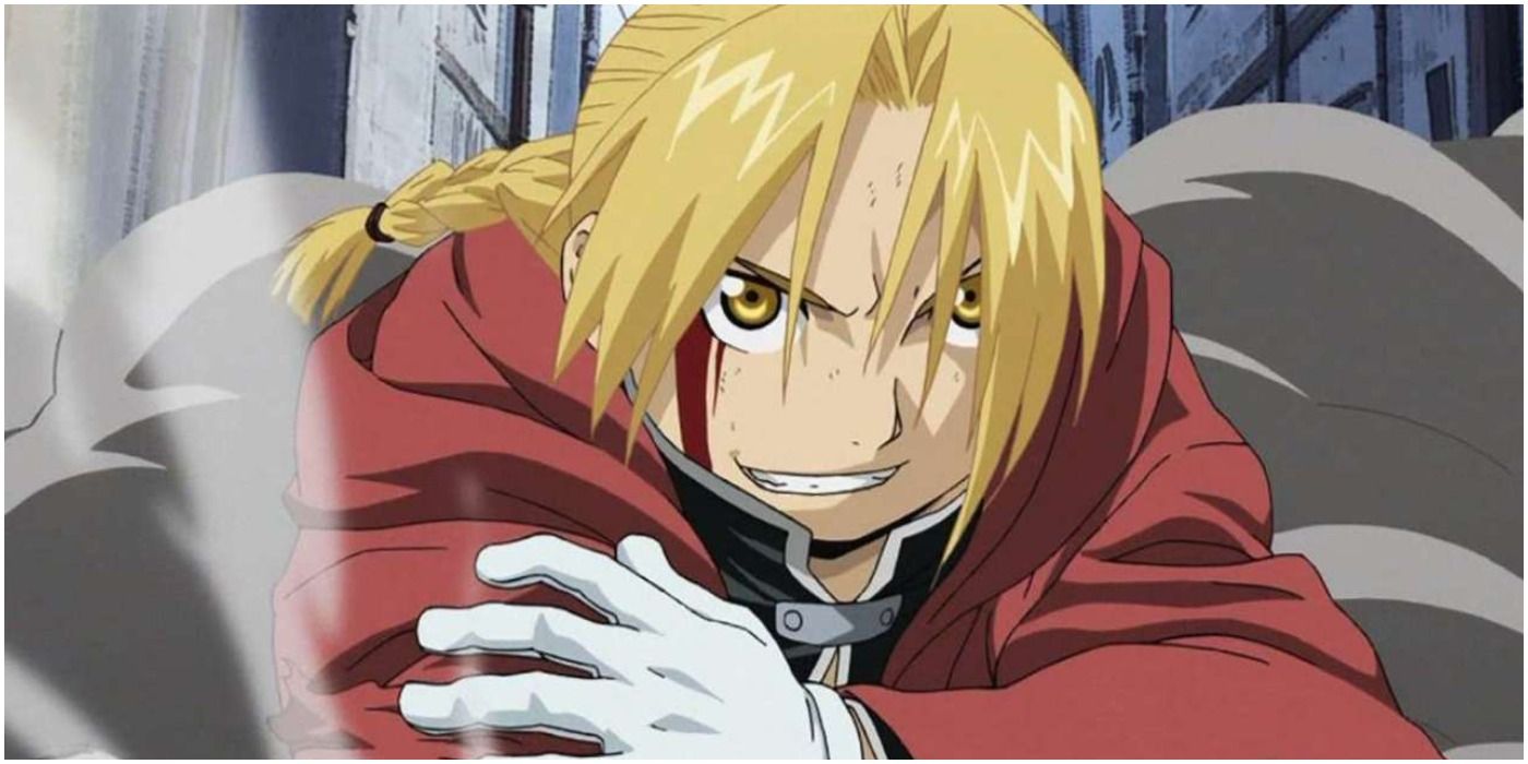 Edward Elric holds his cyborg arm and smirks