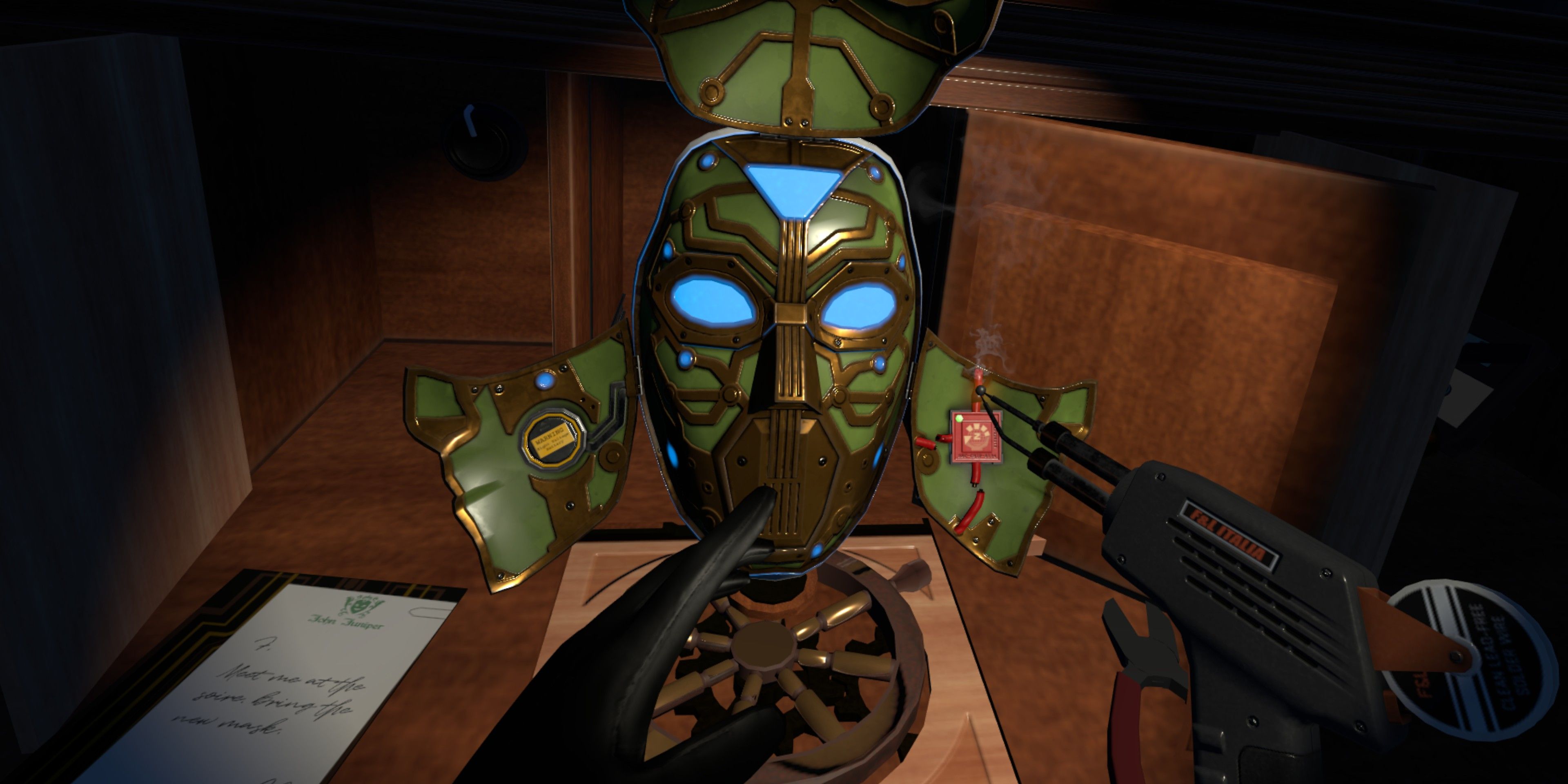 In-game view of I Expect You To Die 2 showing the interior of a mask filled with wiring and a soldering gun held to the wires.