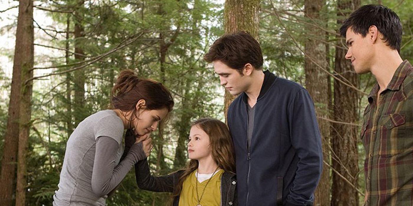 Edward and Jacob look on as Renesmee touches Bella's face in Twilight: Breaking Dawn part 2