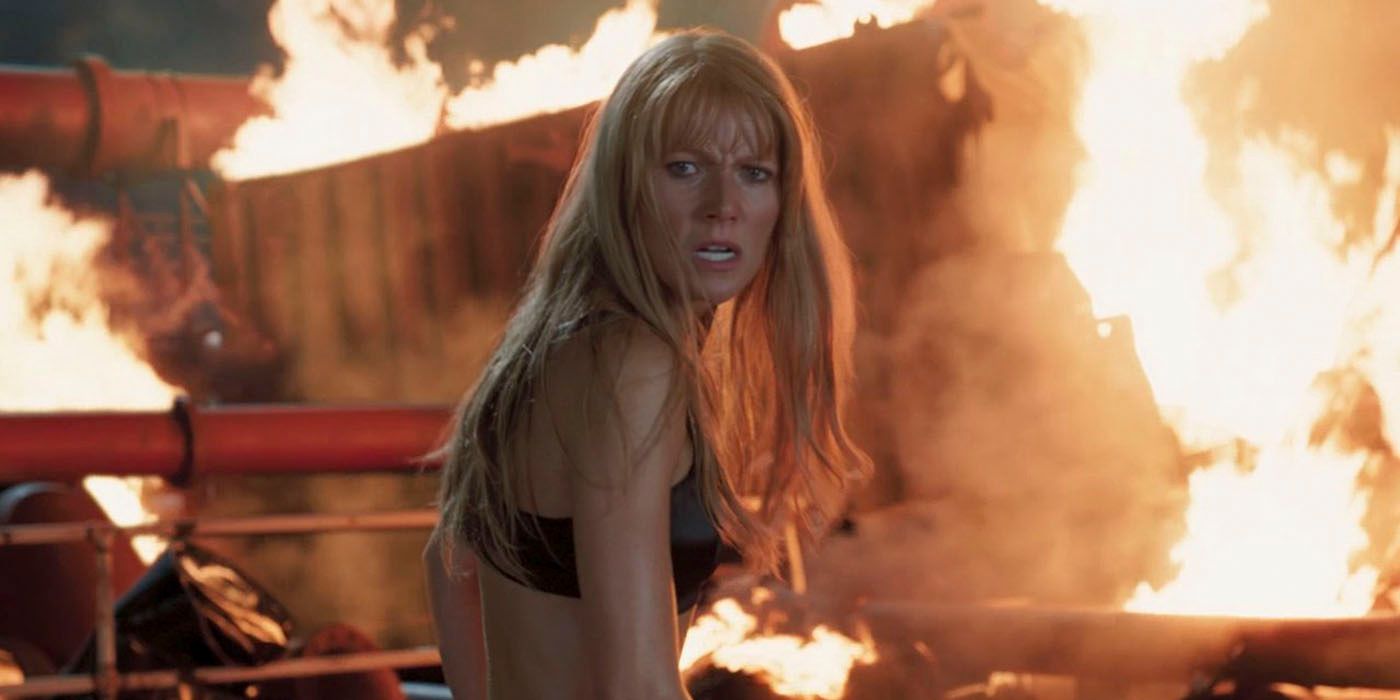 MCU's Pepper Potts stands looking angry in front of a major fire and rubble.