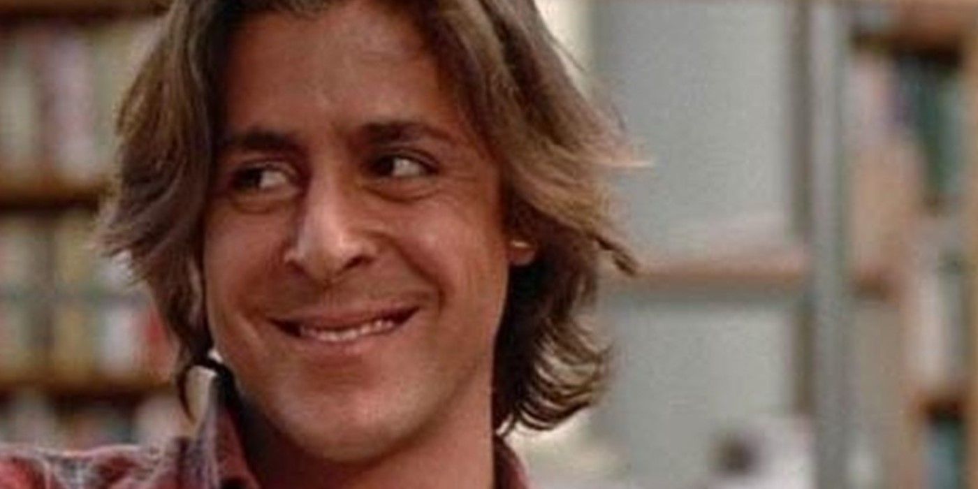 Judd Nelson as John Bender grinning in the library of the Breakfast Club detention