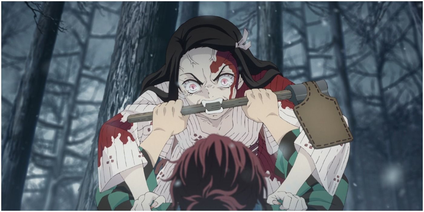 Tanjiro using an ax hilt to hold Nezuko back during a demonic outburst.