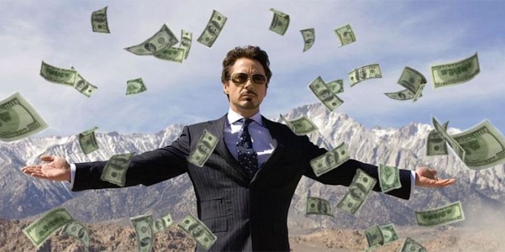 Tony Stark standing in desert flying money