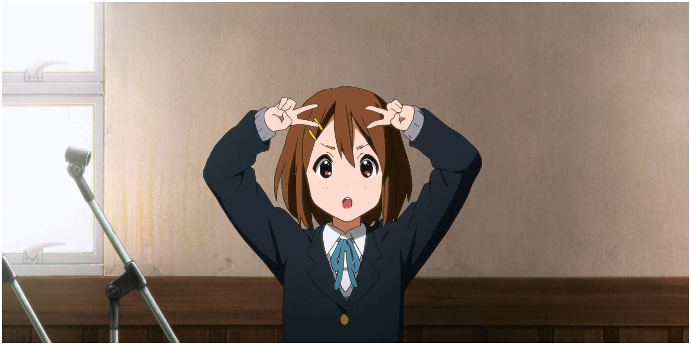 Yui poses with peace fingers on head