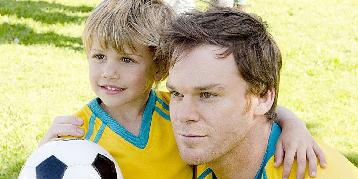 Dexter and son in soccer uniforms with ball
