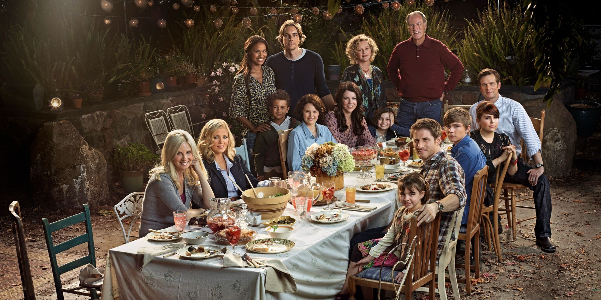 The entire cast of parenthood around the backyard table