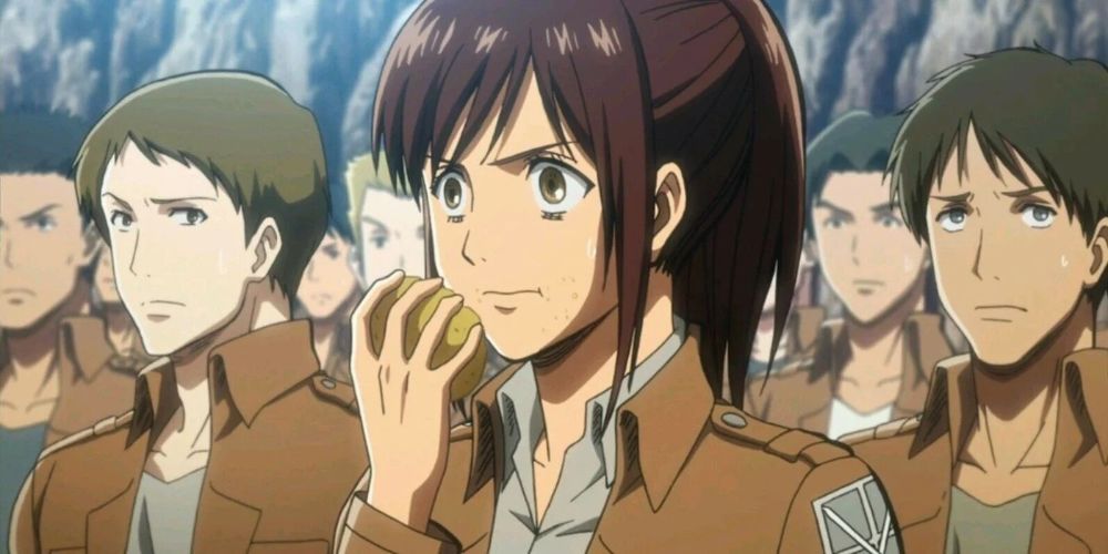 Sasha eating a potato during training in Attack on Titan.