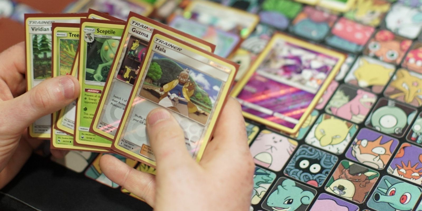 A player holds a hand of Pokémon cards