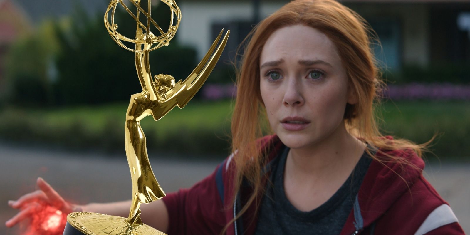Elizabeth Olsen as Scarlet Witch staring longingly at an Emmy Award