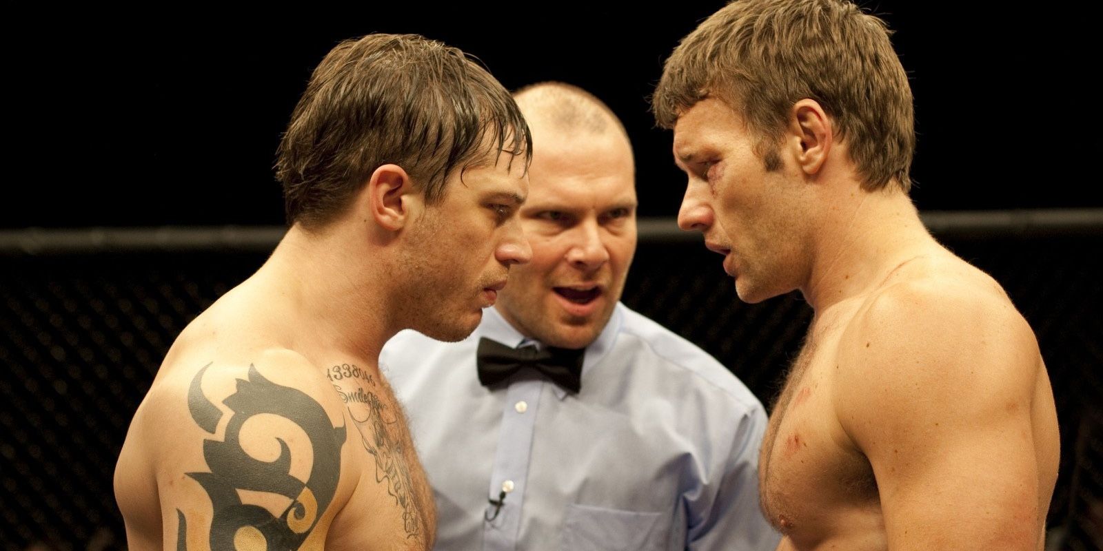 Tom Hardy, Joel Edgerton and a ref standing in the ring in Warriror