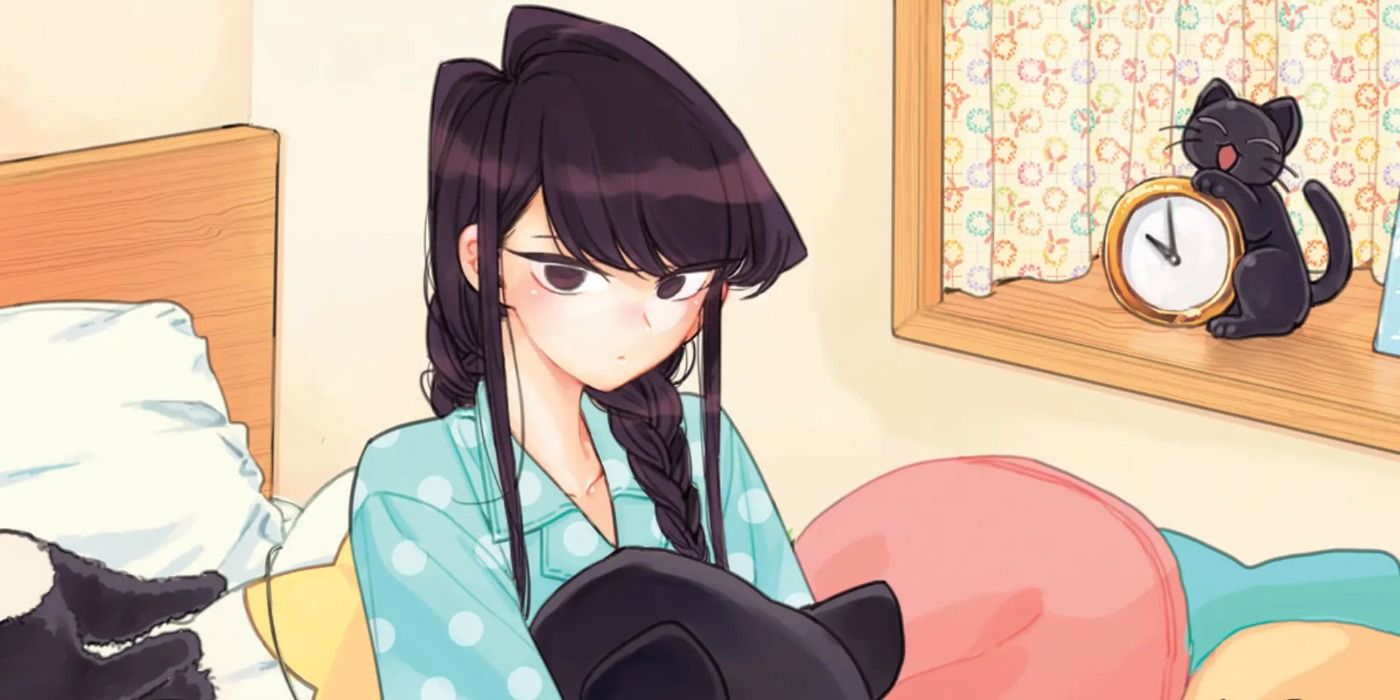 Shoko Komi sitting on her bed and holding a cat plush in Komi Can't Communicate manga