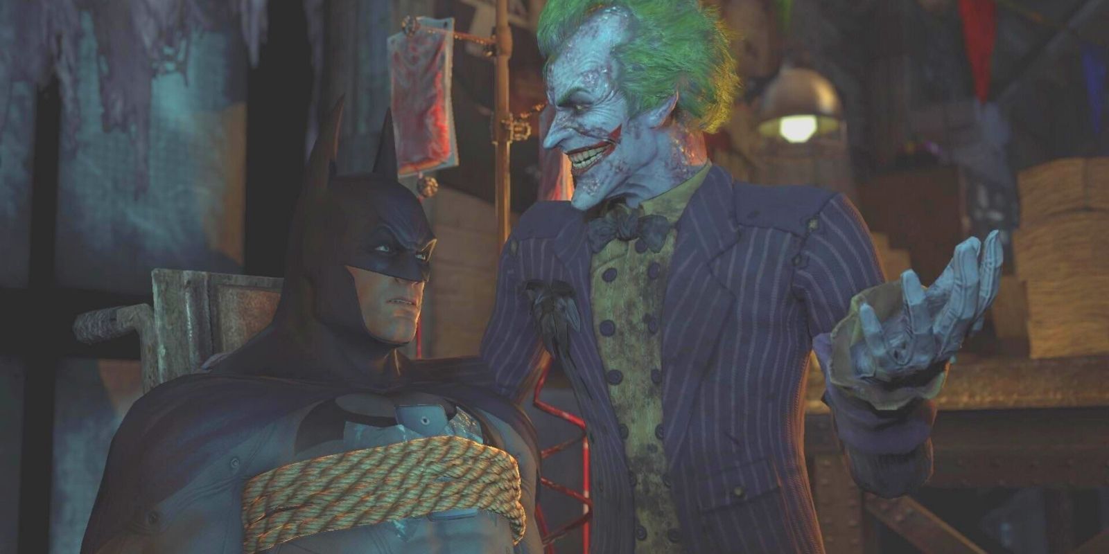 Batman, tied to a chair, listens to The Joker in Batman: Arkham City