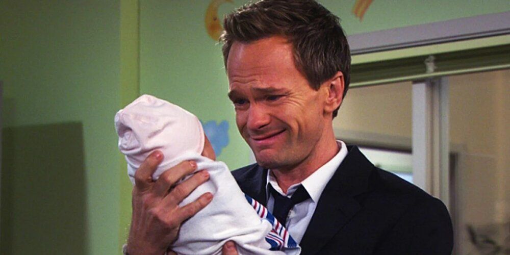Barney holds his newborn daughter Sadie in How I Met Your Mother
