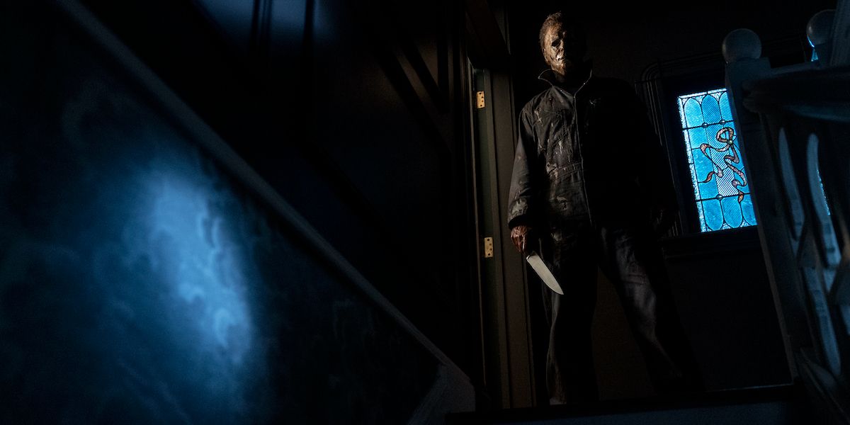 Michael Myers stands in a stairwell with a knife in Halloween Kills