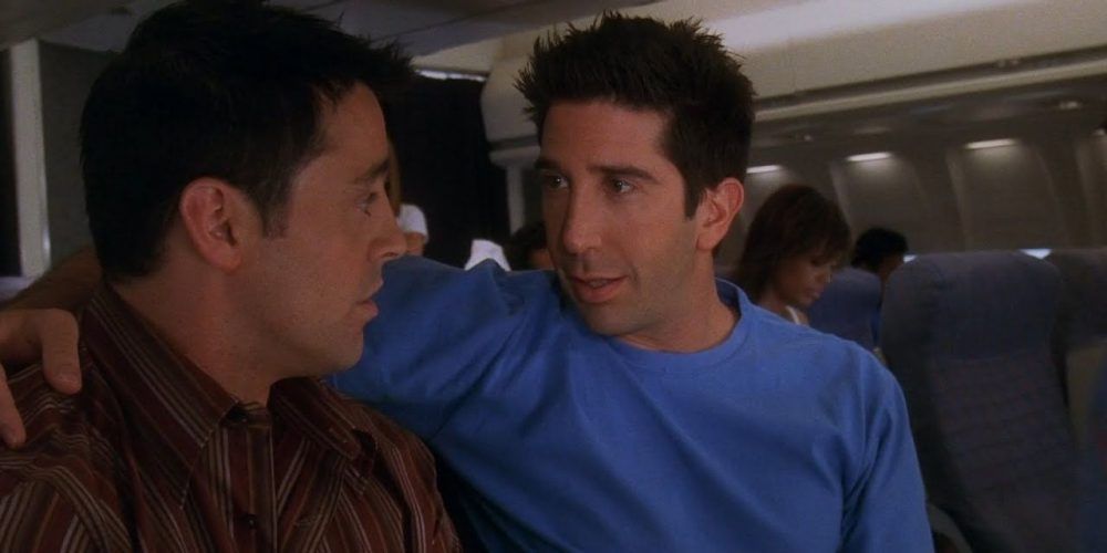 Ross sits with his arm around Joey's shoulders in an Airplane in Friends.