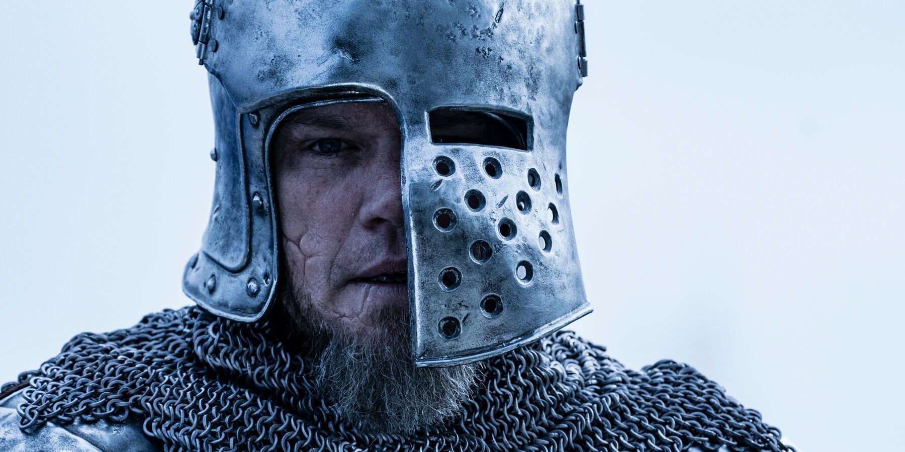 Matt Damon wears a medieval helmet in a still from The Last Duel.