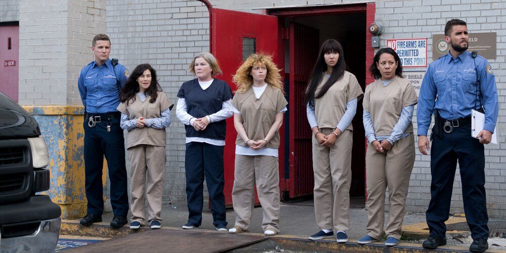 Guards and prisoners outside the prison in Orange is the New Black.