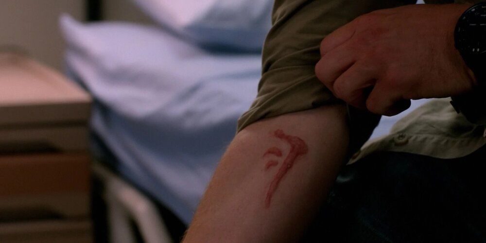 Dean examines the Mark of Cain in Supernatural