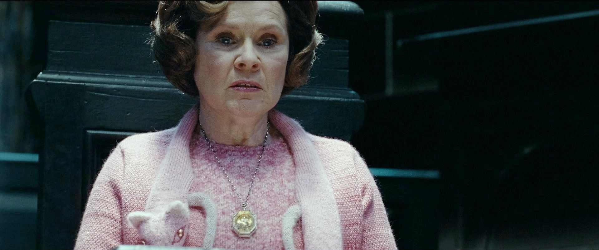 Dolores Umbridge wearing the Slytherin locket in Harry Potter