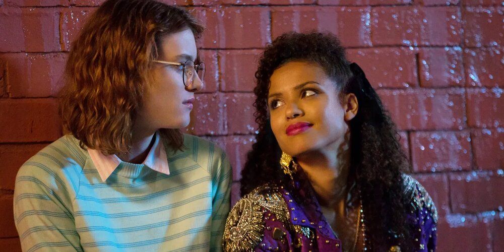 Yorkie and Kelly look into one another's eyes in San Junipero Black Mirror