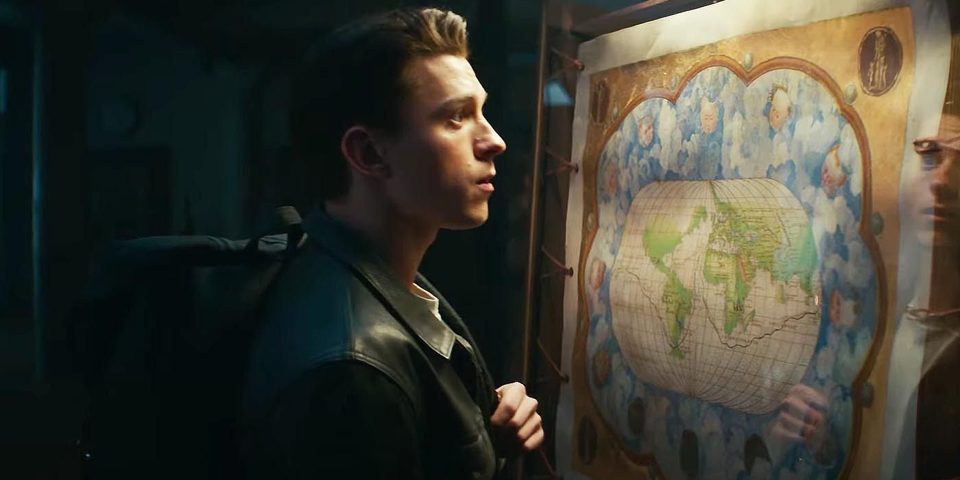 Tom Holland as Nathan Drake looking at a map in Uncharted
