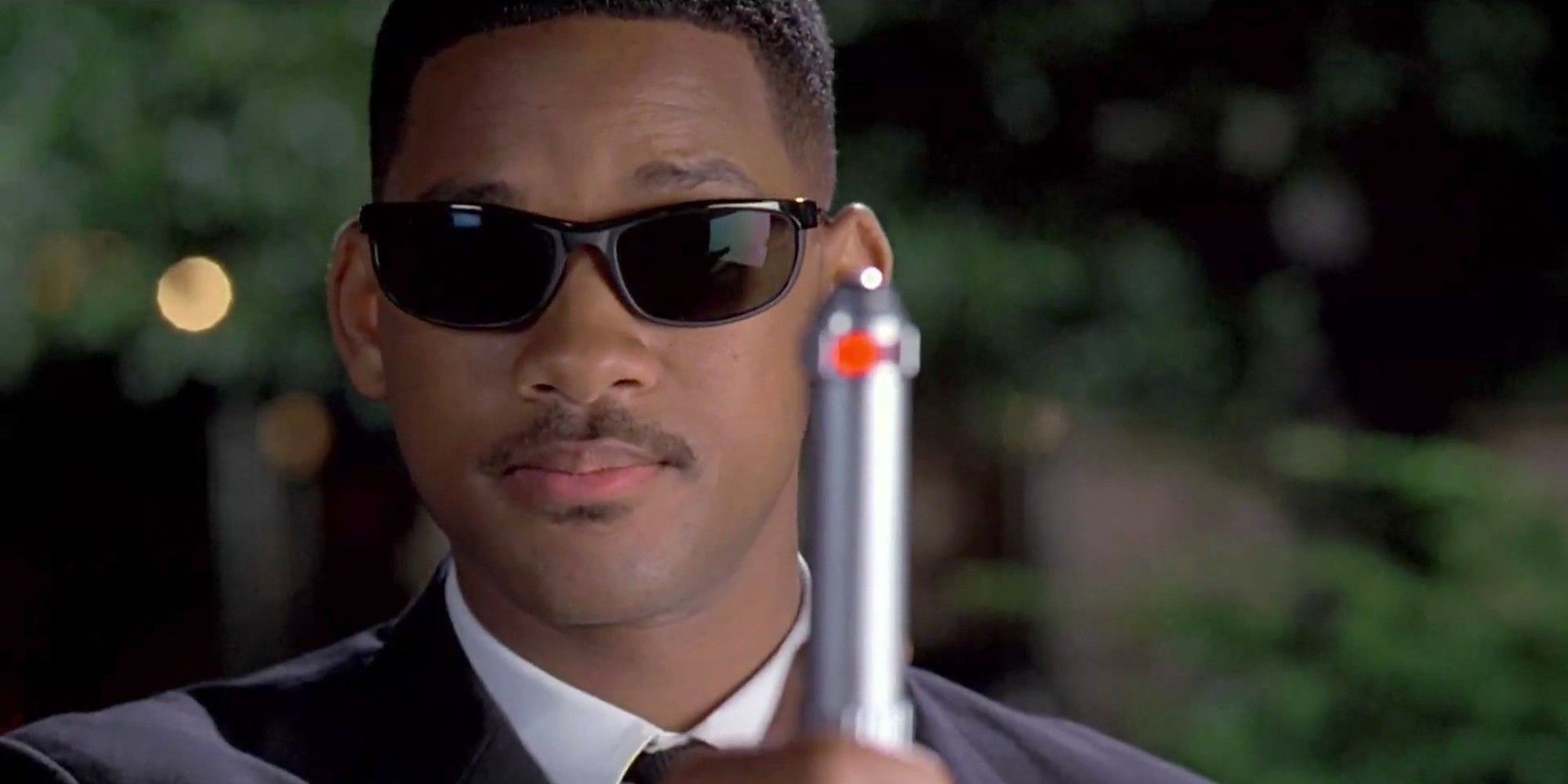 Will Smith - as Agent J - holds up the neuralyzer in Men in Black