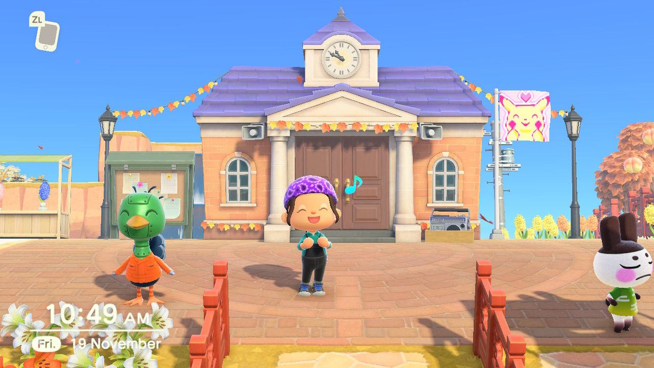A player uses an emote in front of the Animal Crossing: New Horizons Town Hall.