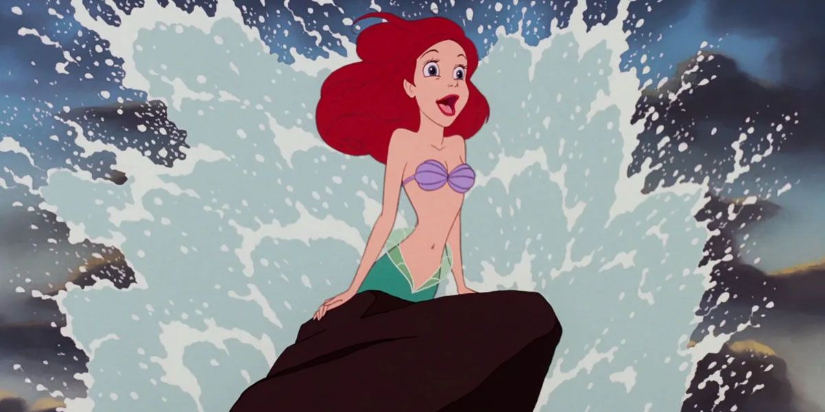 Ariel singing on a rock with water splashing behind her in The Little Mermaid