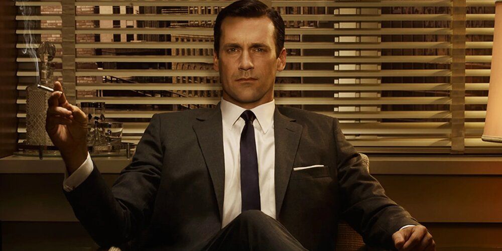 The iconic image of Don Draper sat at his desk and smoking a cigarette from Mad Men
