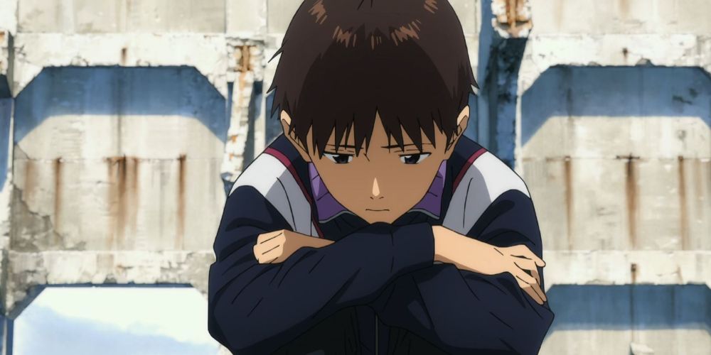 Shinji From Evangelion Sits With His Arms Crossed on His Knees, Looking at the Ground