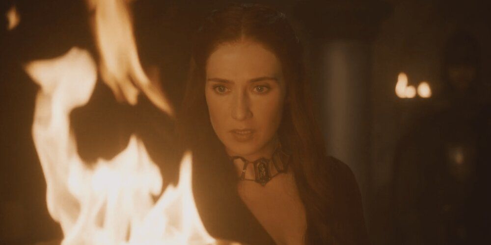 Melisandre looking into a fire at Winterfell in Game of Thrones.