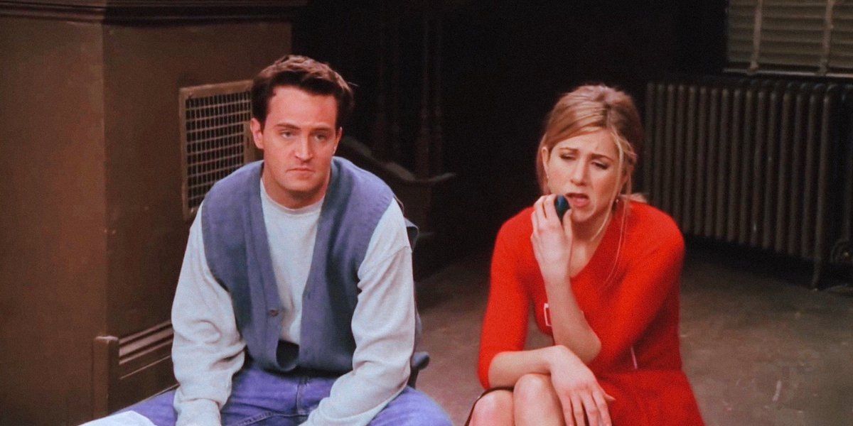 Rachel Green and Chandler Bing sit together dejectedly in Friends.