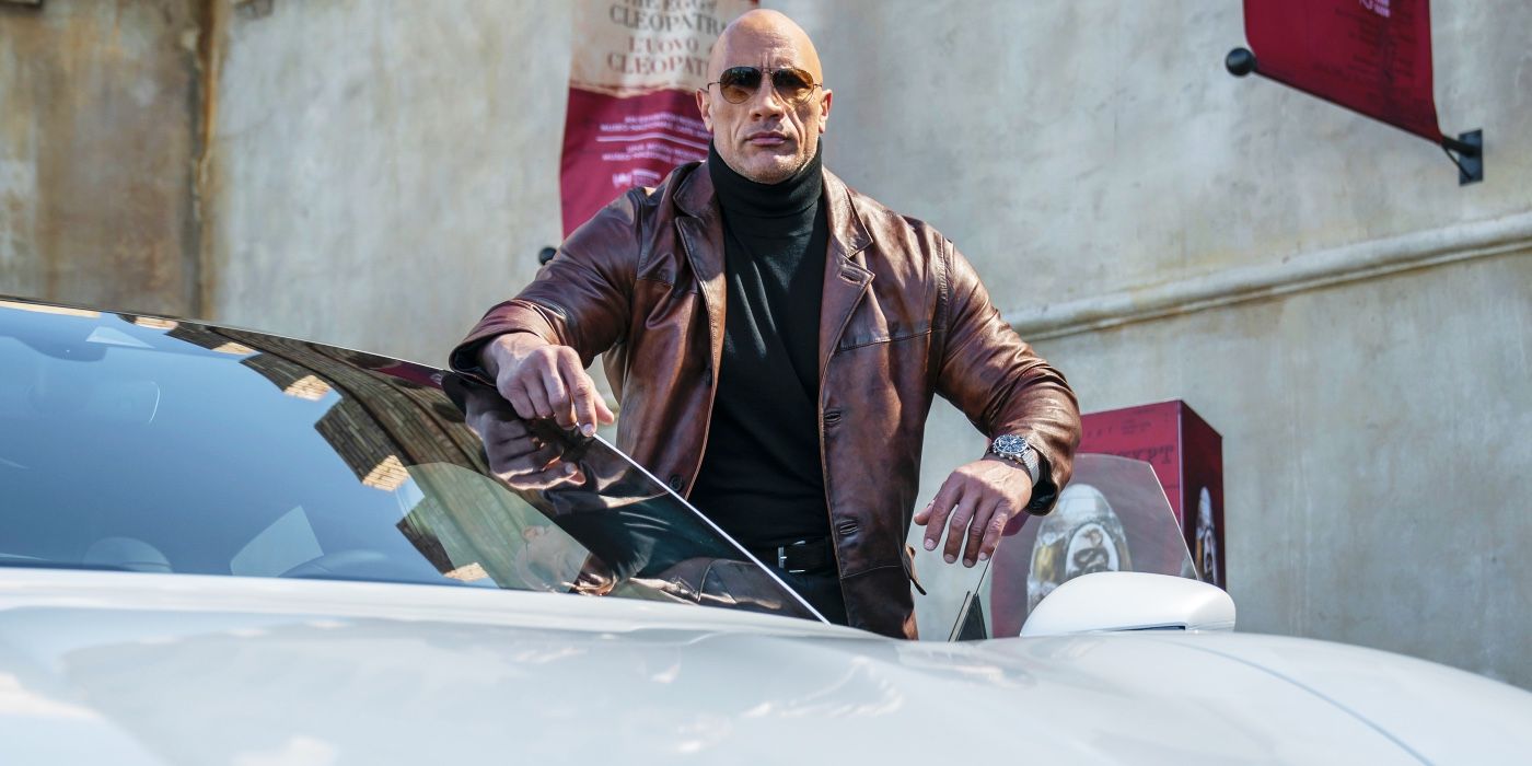 Dwayne Johnson with his car in Red Notice