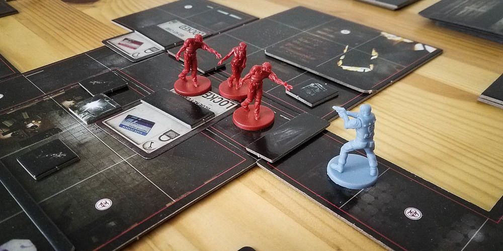 Leon Kennedy fighting off three zombies in Resident Evil 2: The Board Game.
