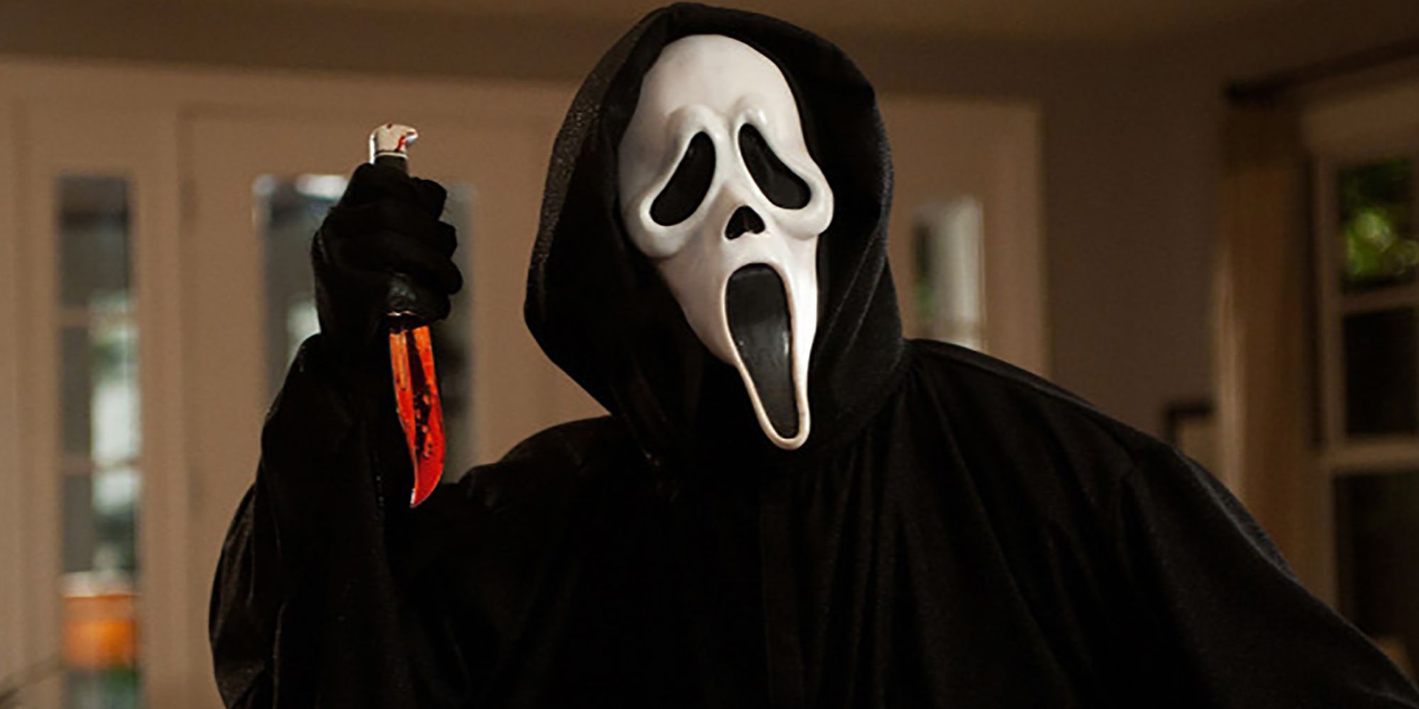 Ghostface holding a bloody knife in Scream
