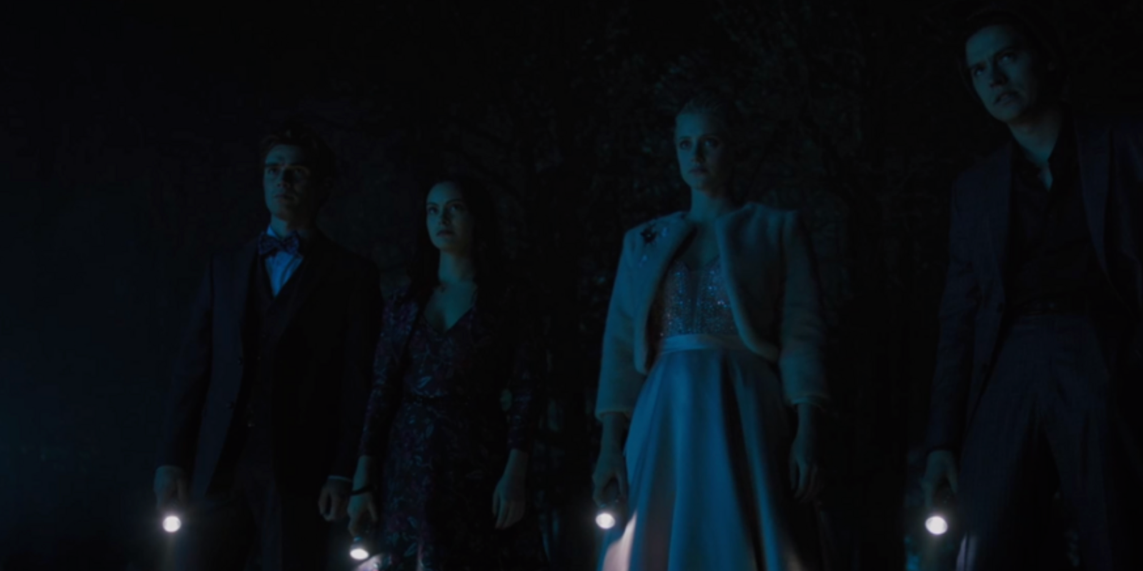 the riverdale gang standing together with flashlights