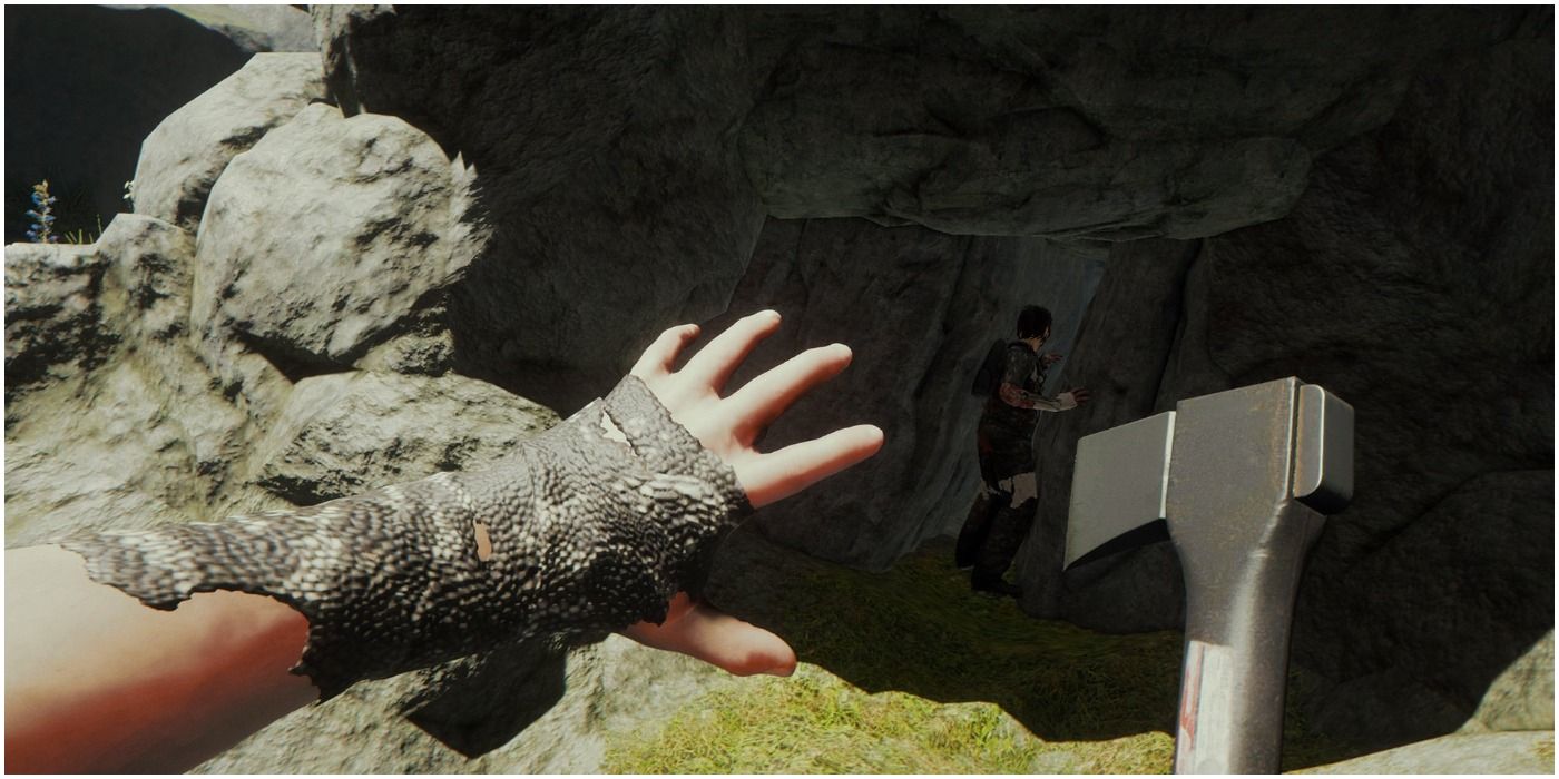 The Forest Gameplay Showing The Players Hand While Holding An Axe In The Other