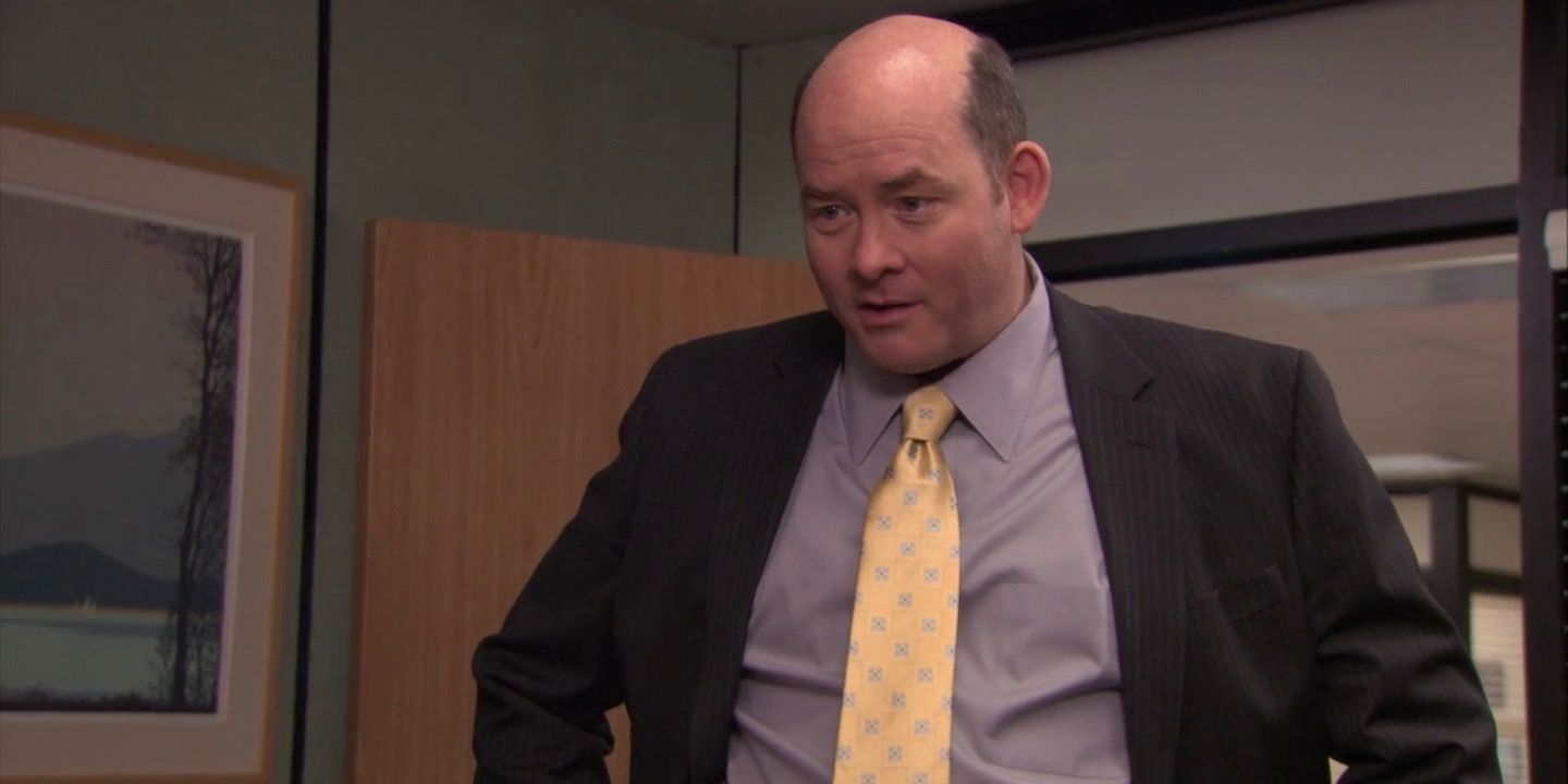 Todd Packer standing in Michael's office in a suit on The Office