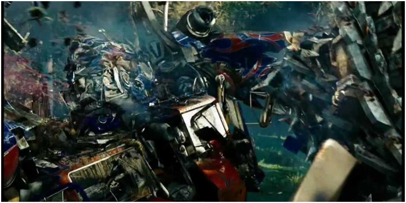 An image of a battered Optimus Prime in a fight scene taking place in a forest from Transformers: Revenge of the Fallen.