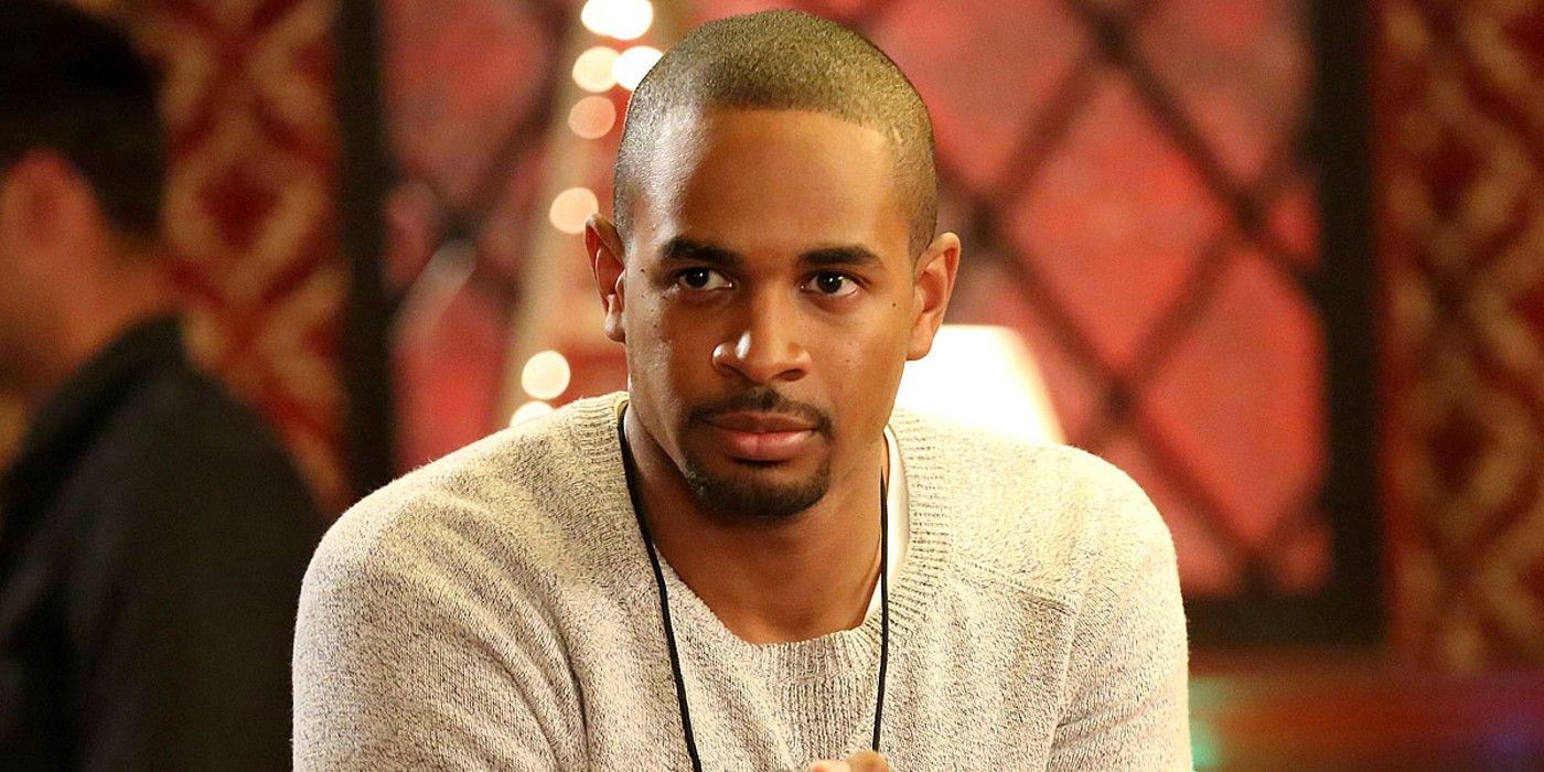 Coach (played by Damon Wayans Jr.) from New Girl sits in a bar and looks off into the distance