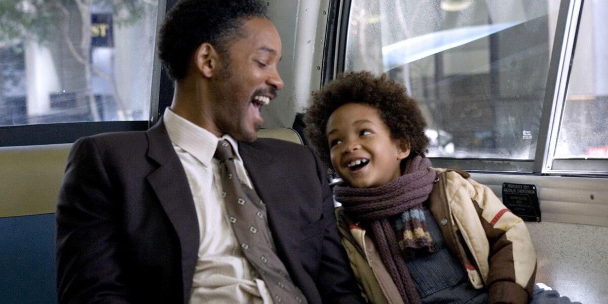 Chris Gardner and his son laughing on the bus