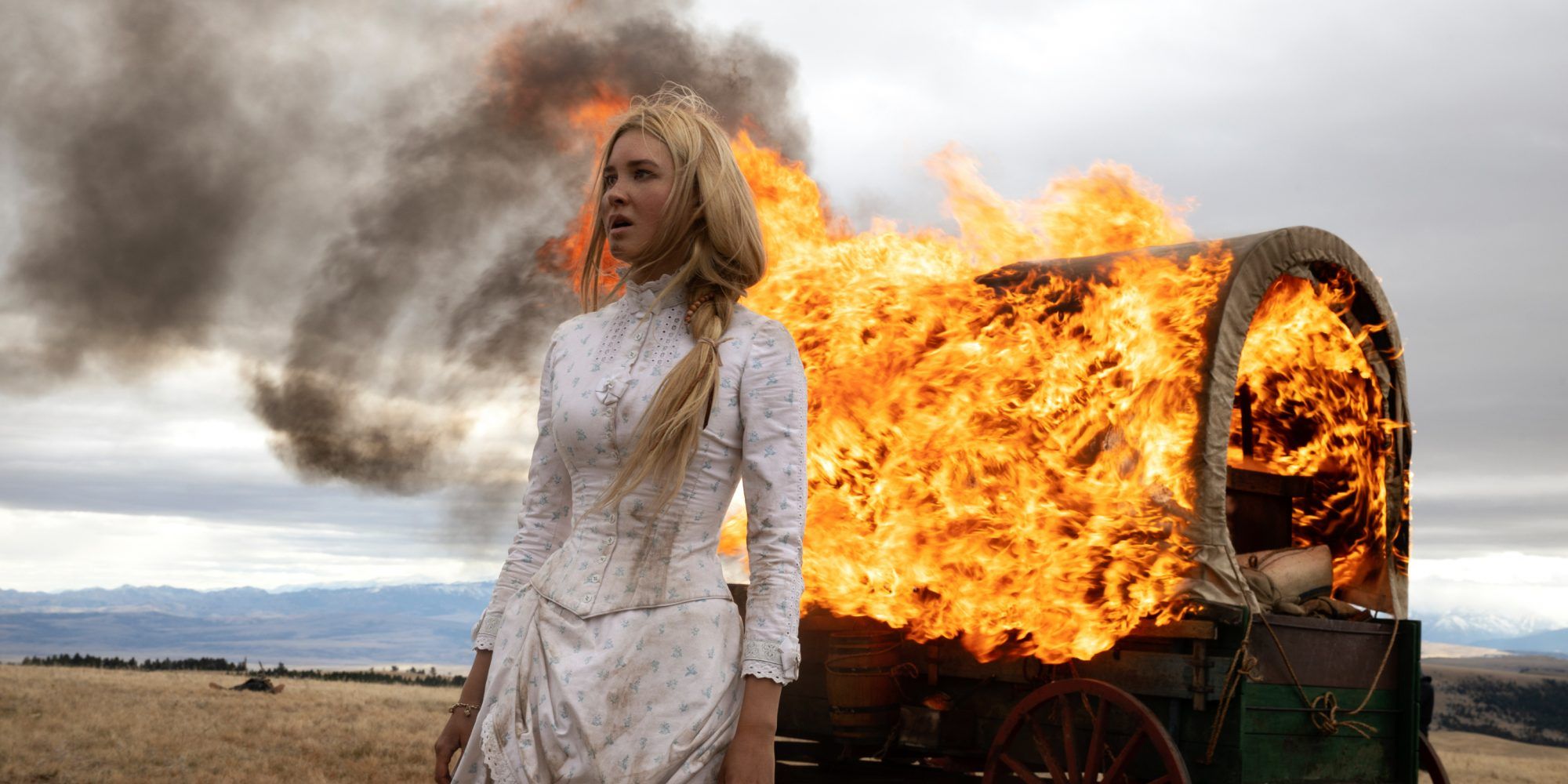 Elsa walks away from a burning wagon