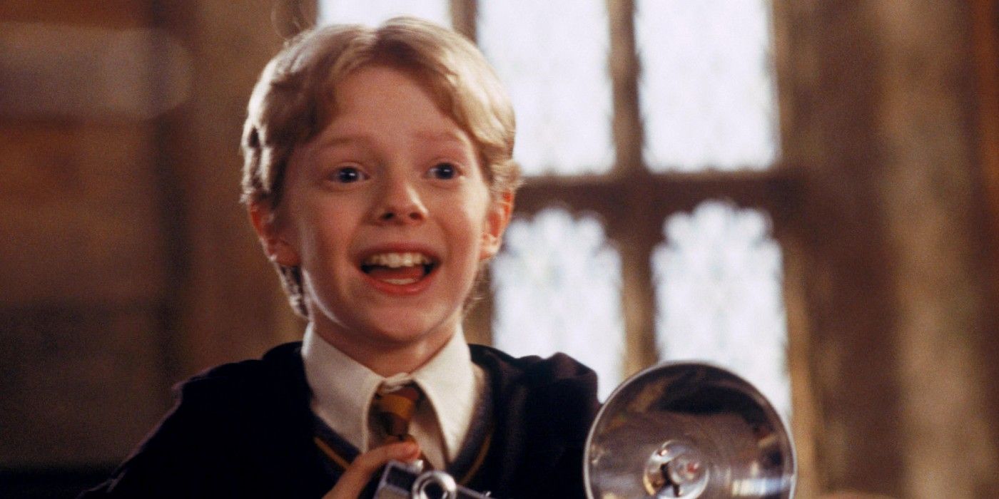 Colin Creevey in his Hogwarts holding his camera uniform in Harry Potter and the Chamber of Secrets