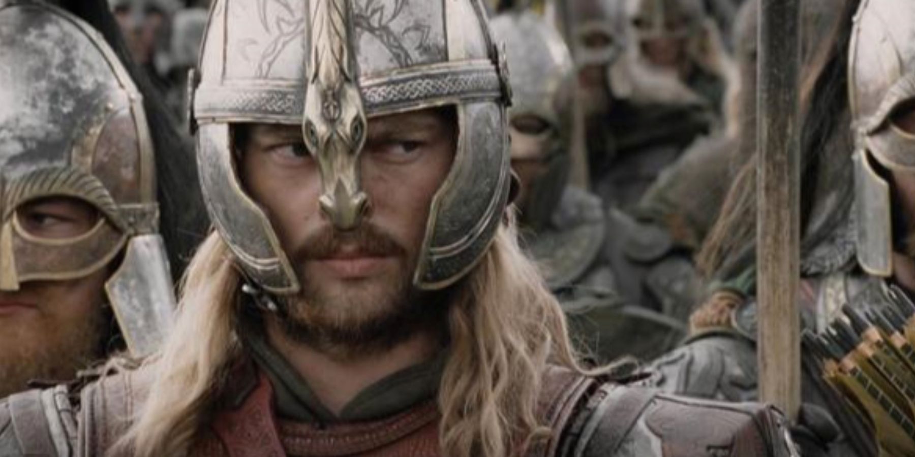 Eomer glanes to the side while standing with the Rohirrim in The Lord of the Rings