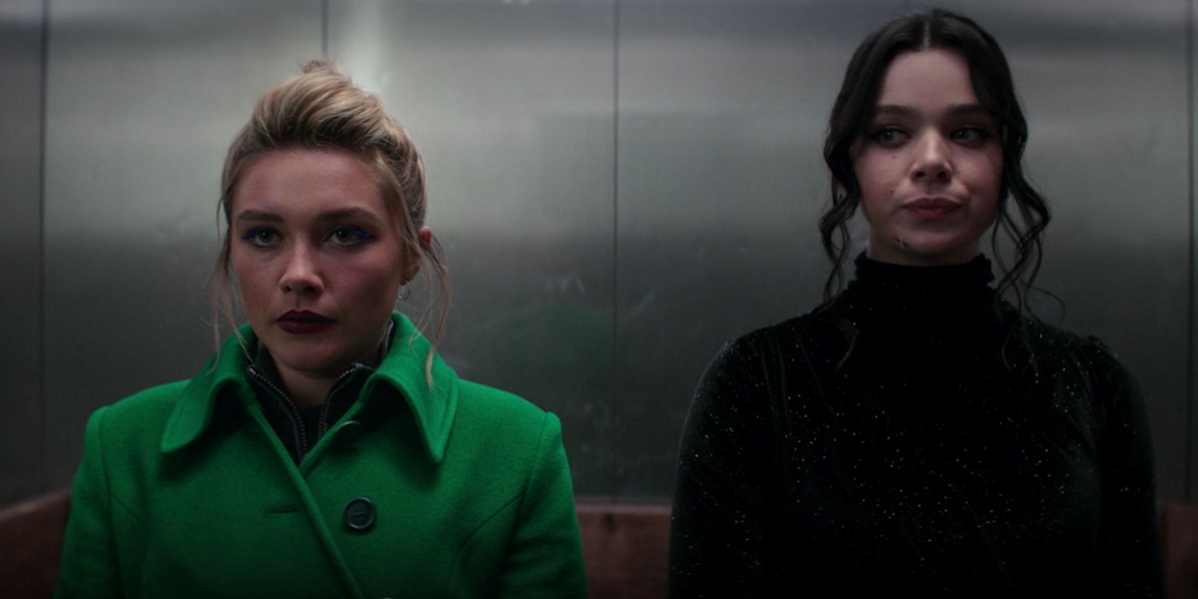 Yelena Belova (Florence Pugh) and Kate Bishop (Hailee Steinfeld) standing next to each other in an elevator.